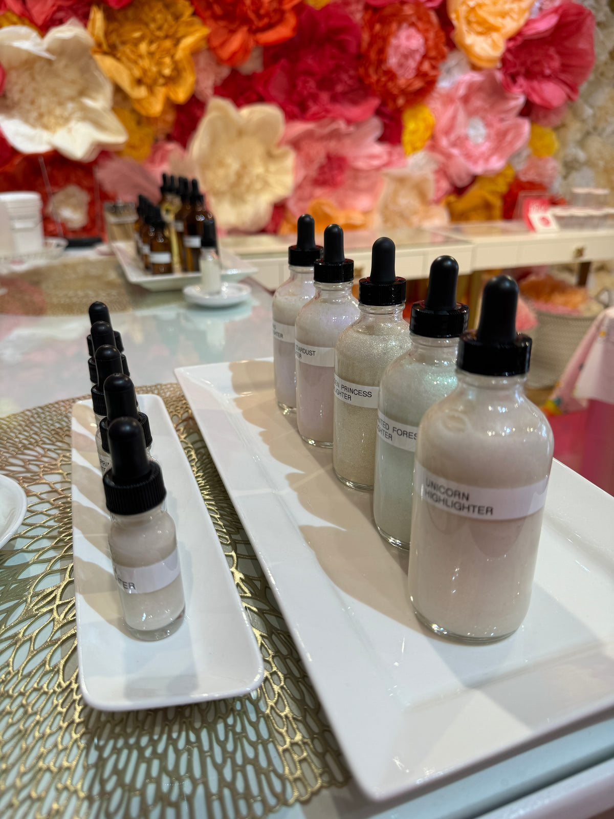 Bottles of serum base lined up on trays at the Beauty Bar