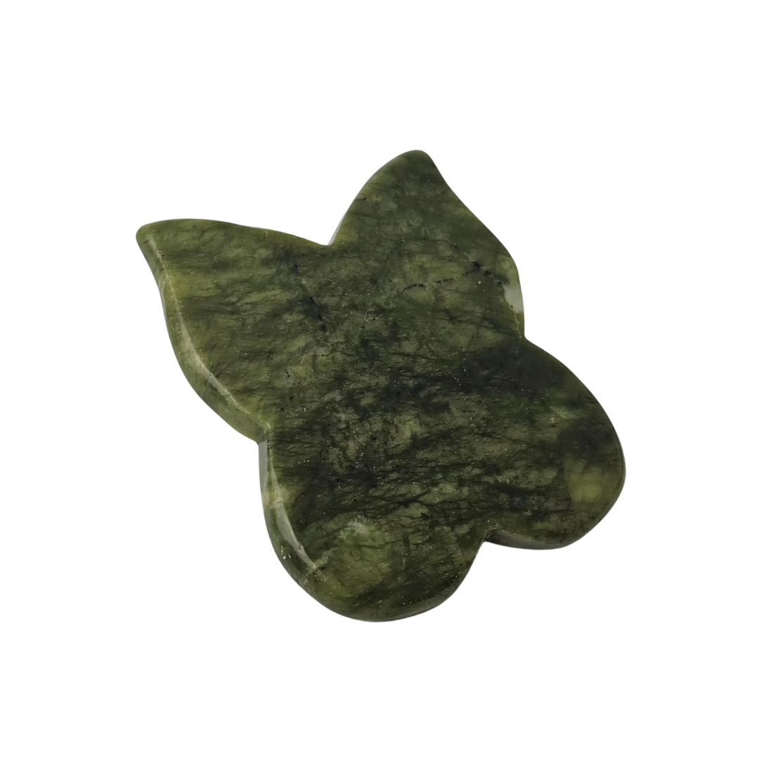 The green stone butterfly tool lying at an angle