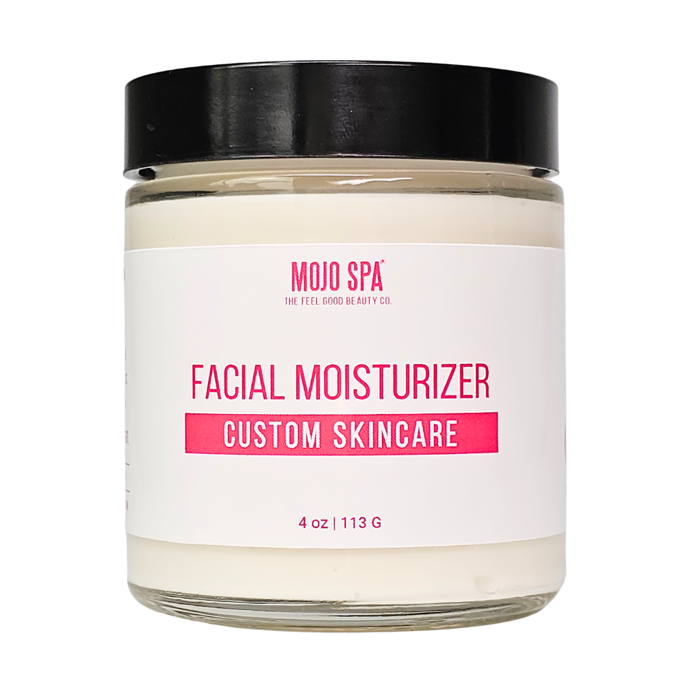 A 4 oz glass jar of white cream with a black lid and a Mojo Spa custom skincare label