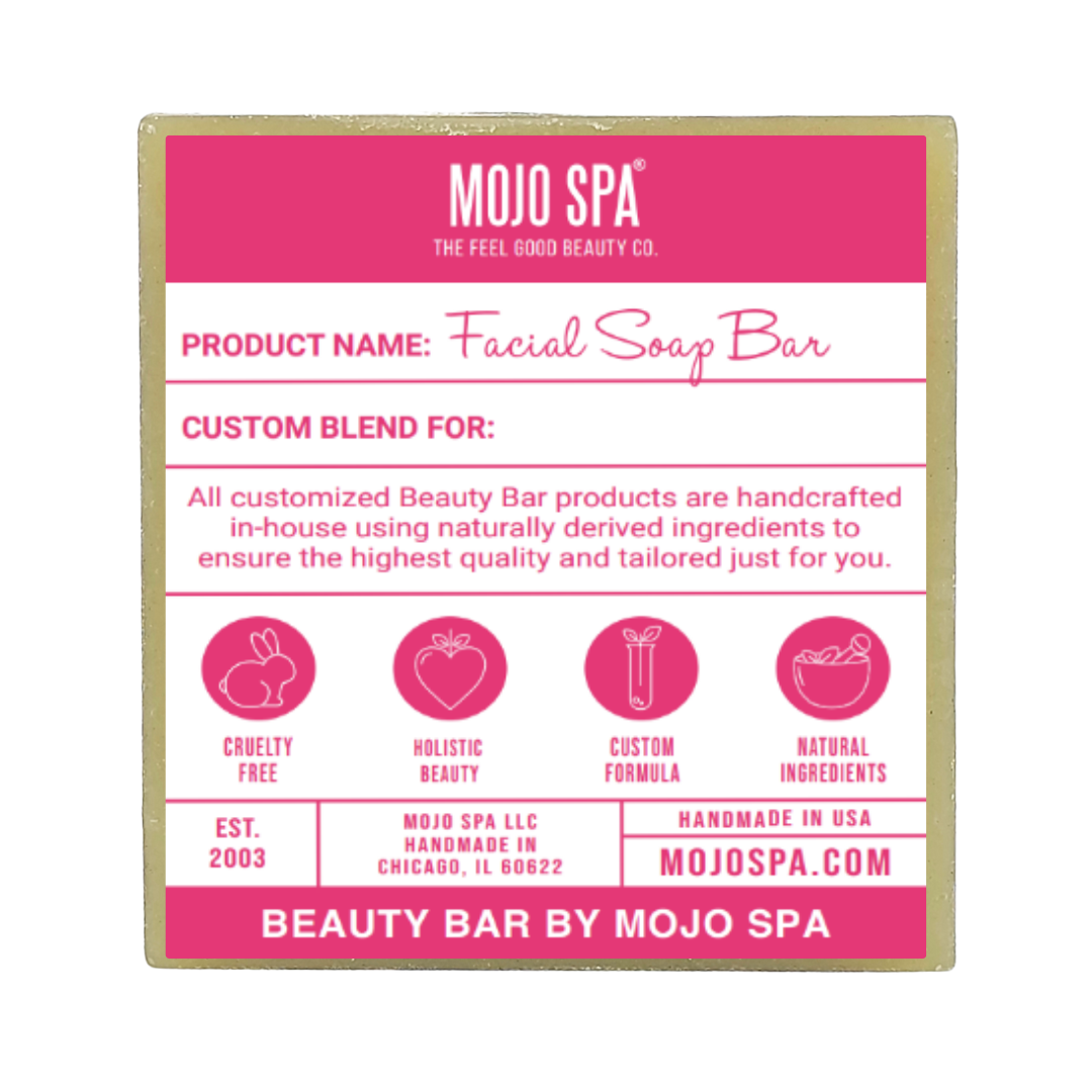 Custom facial cleansing soap, a square pale green bar with a pink and white label reading Facial Soap Bar