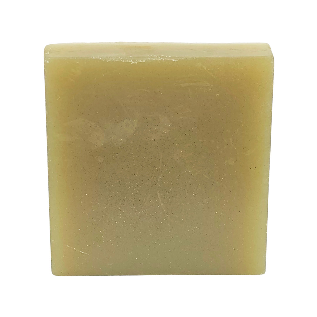 The plain side of the soap bar, a pale green square with no label