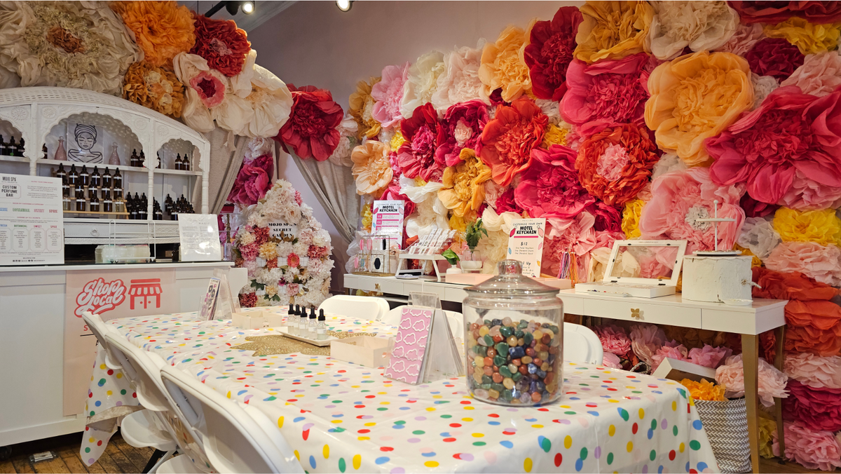 The Beauty Bar table set for a party, with a polka dot tablecloth beside the product display