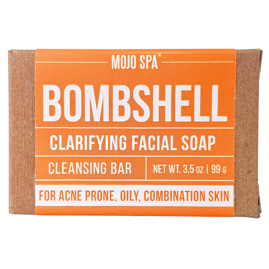 Bombshell clarifying facial soap, a 3.5 oz bar in a kraft box wrapped with an orange label