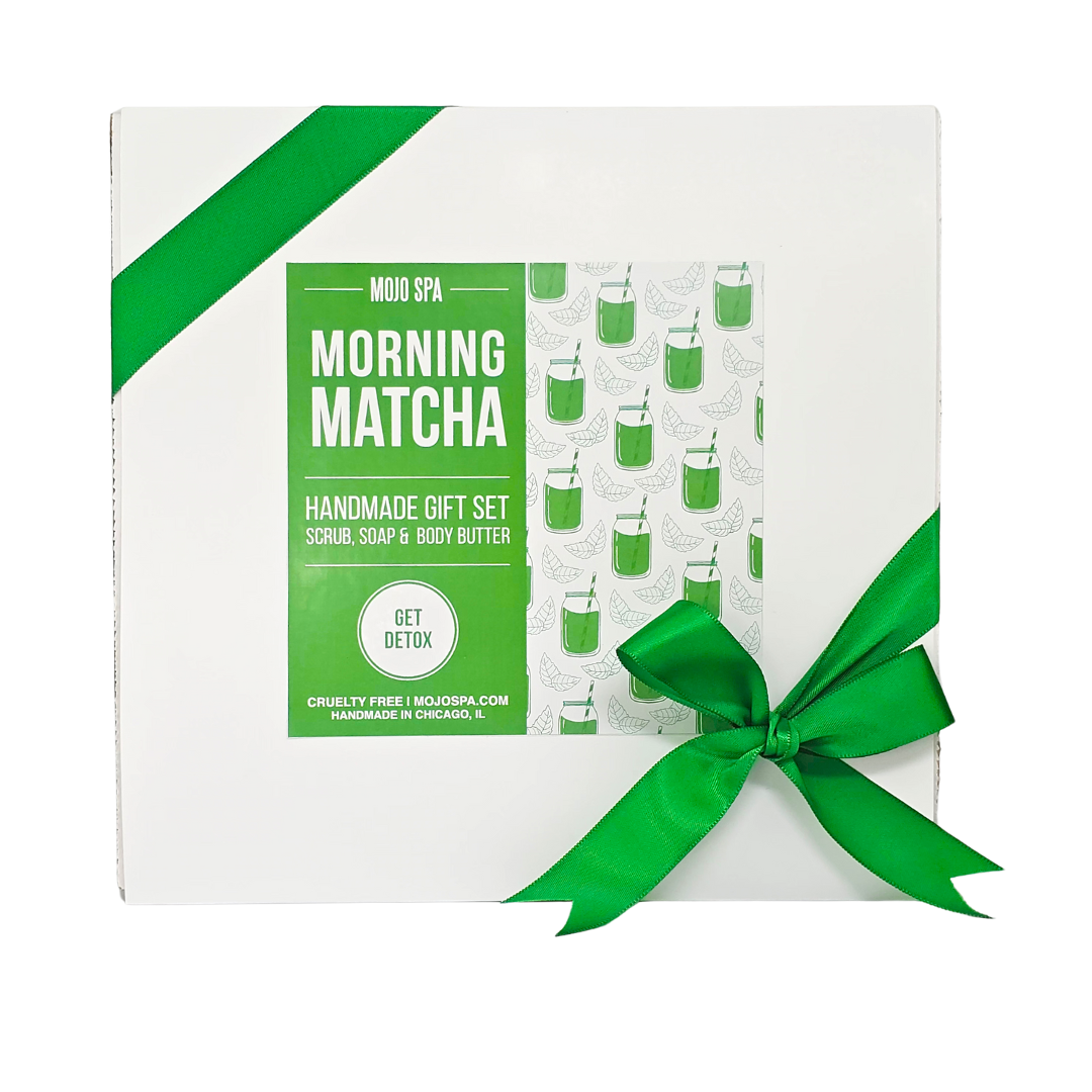 The white gift box alone, tied with a green ribbon