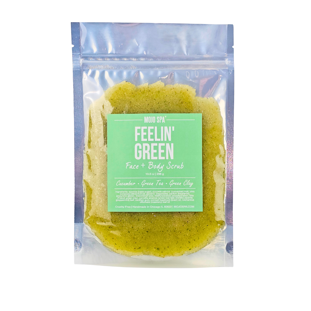 The scrub in a silver zip pouch, label reading Cucumber, Green Tea, Green Clay