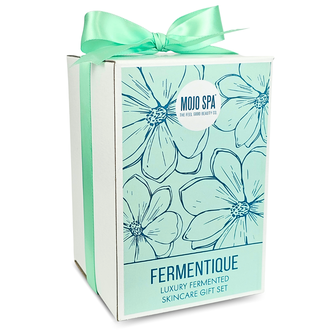 The white gift box at an angle, tied with a mint green ribbon, the flower print on its front