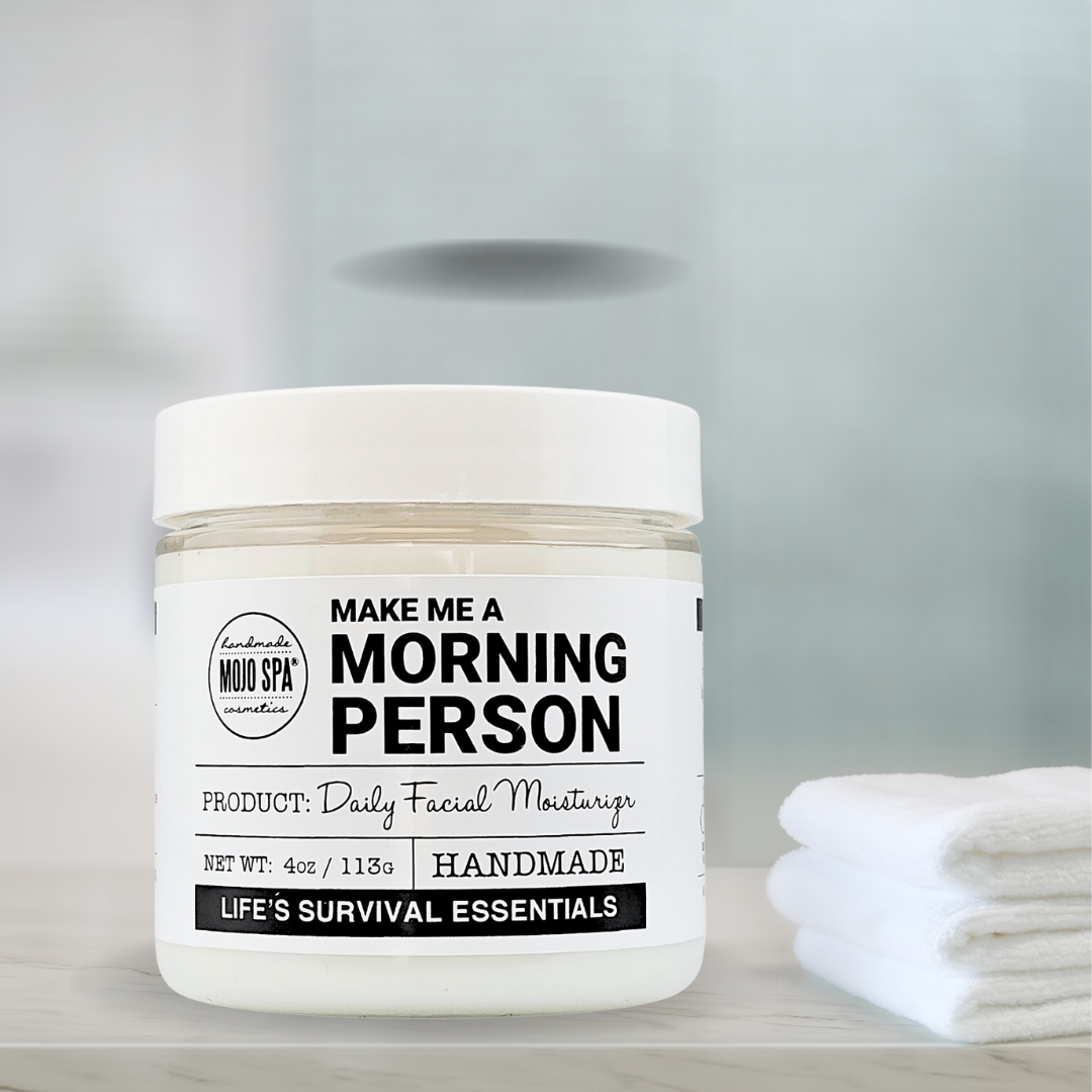 The jar on a shelf beside a stack of folded white washcloths, soft blue-grey background
