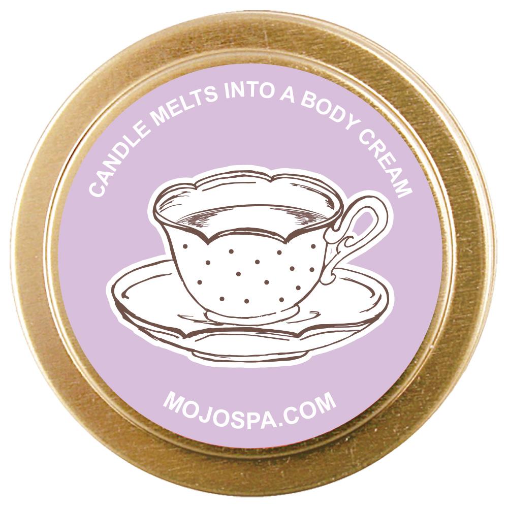 The lavender lid of the gold tin from above, showing a polka dot teacup and the words Candle melts into a body cream
