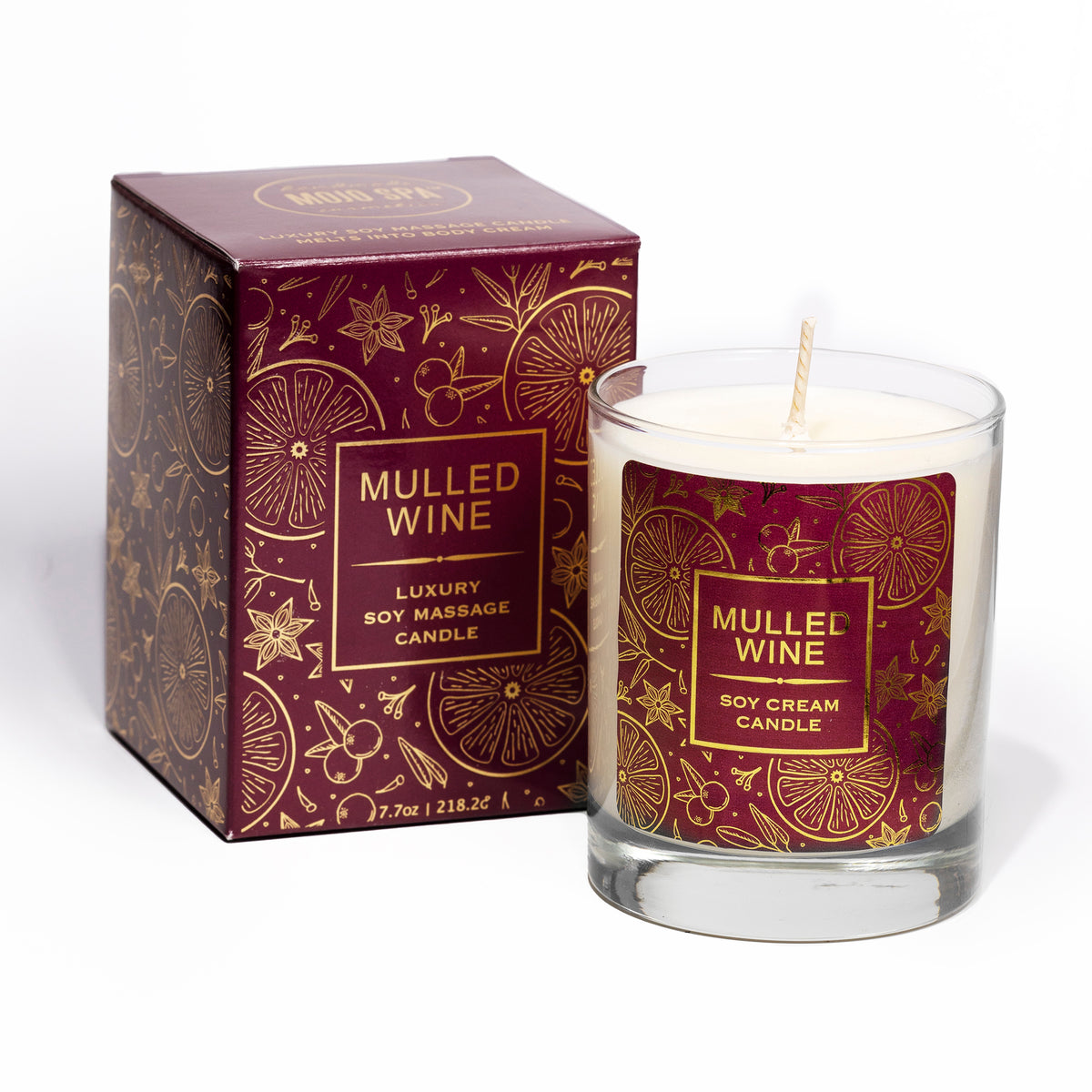The candle in a clear glass beside its burgundy and gold box