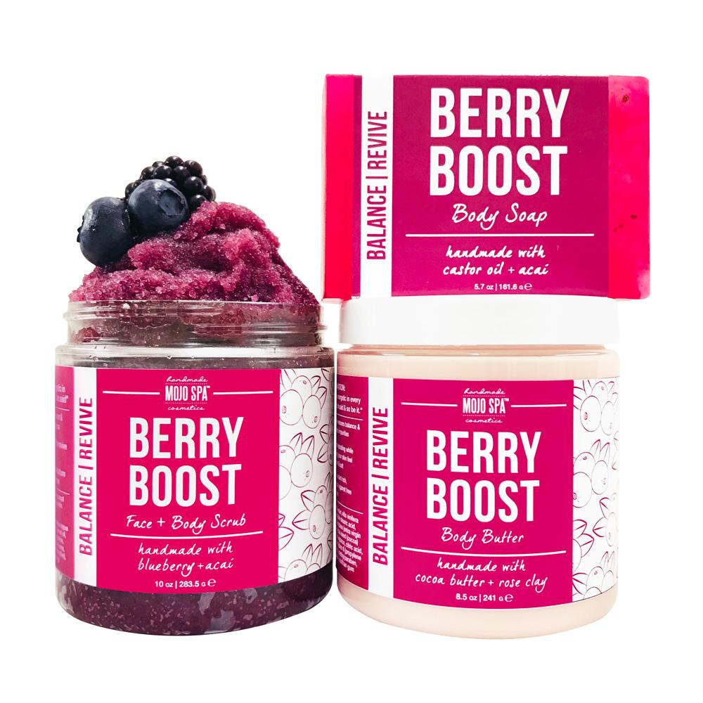 The scrub jar topped with berries, the body butter jar and the soap bar grouped together