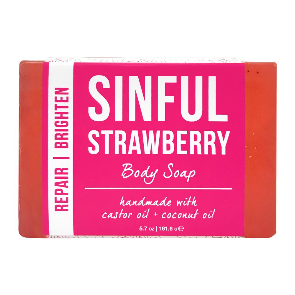 The bar of body soap from the set, its pink label reading Body Soap handmade with castor oil and coconut oil