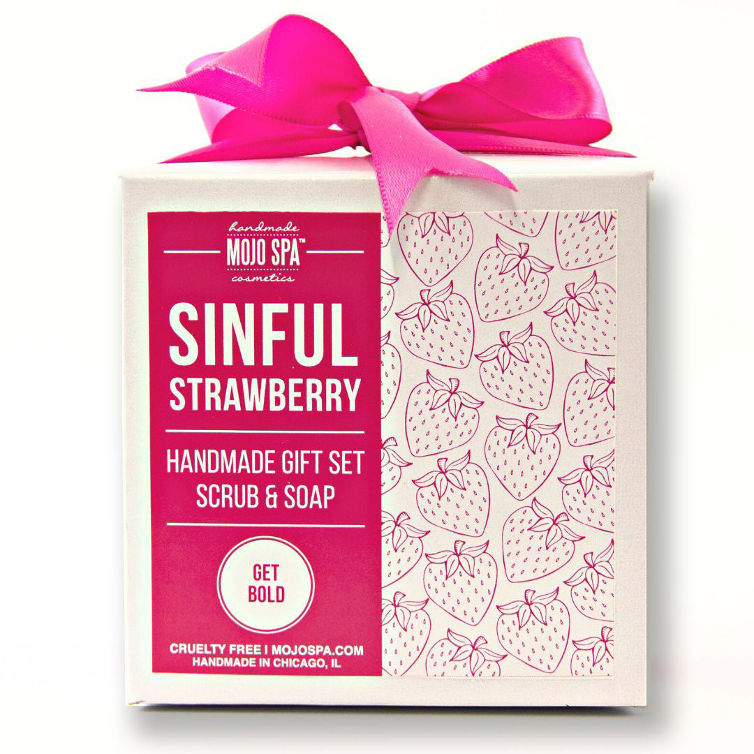 Sinful Strawberry scrub and soap gift set, a white box with a strawberry pattern and a pink label, tied with a bright pink ribbon