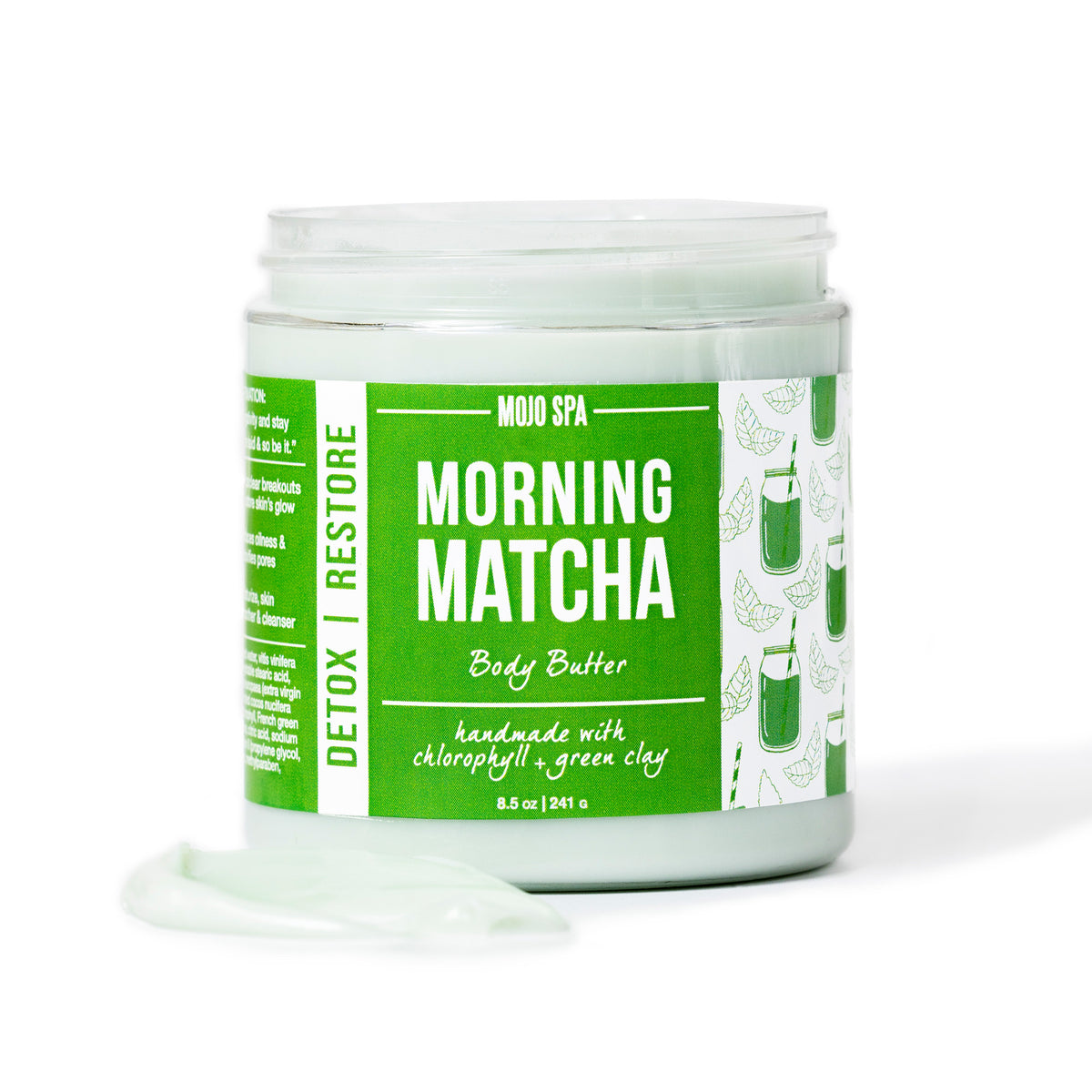 The jar from the front with a swipe of pale green butter on the surface in front