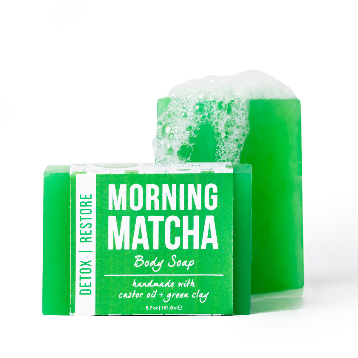 The soap bar in front of a second bar topped with white foam