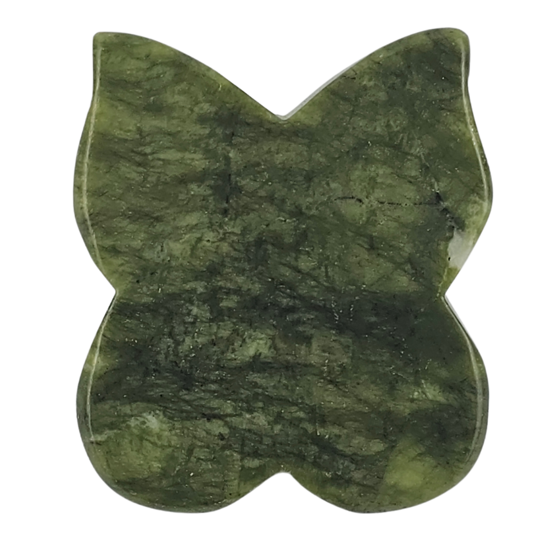 The green stone butterfly tool laid flat from above, mottled dark green