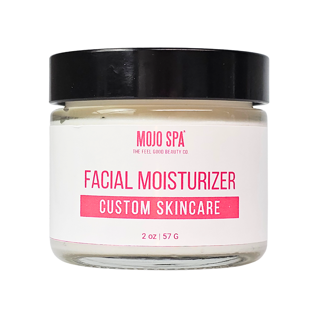 A smaller 2 oz jar of white cream with a black lid and a Mojo Spa custom skincare label
