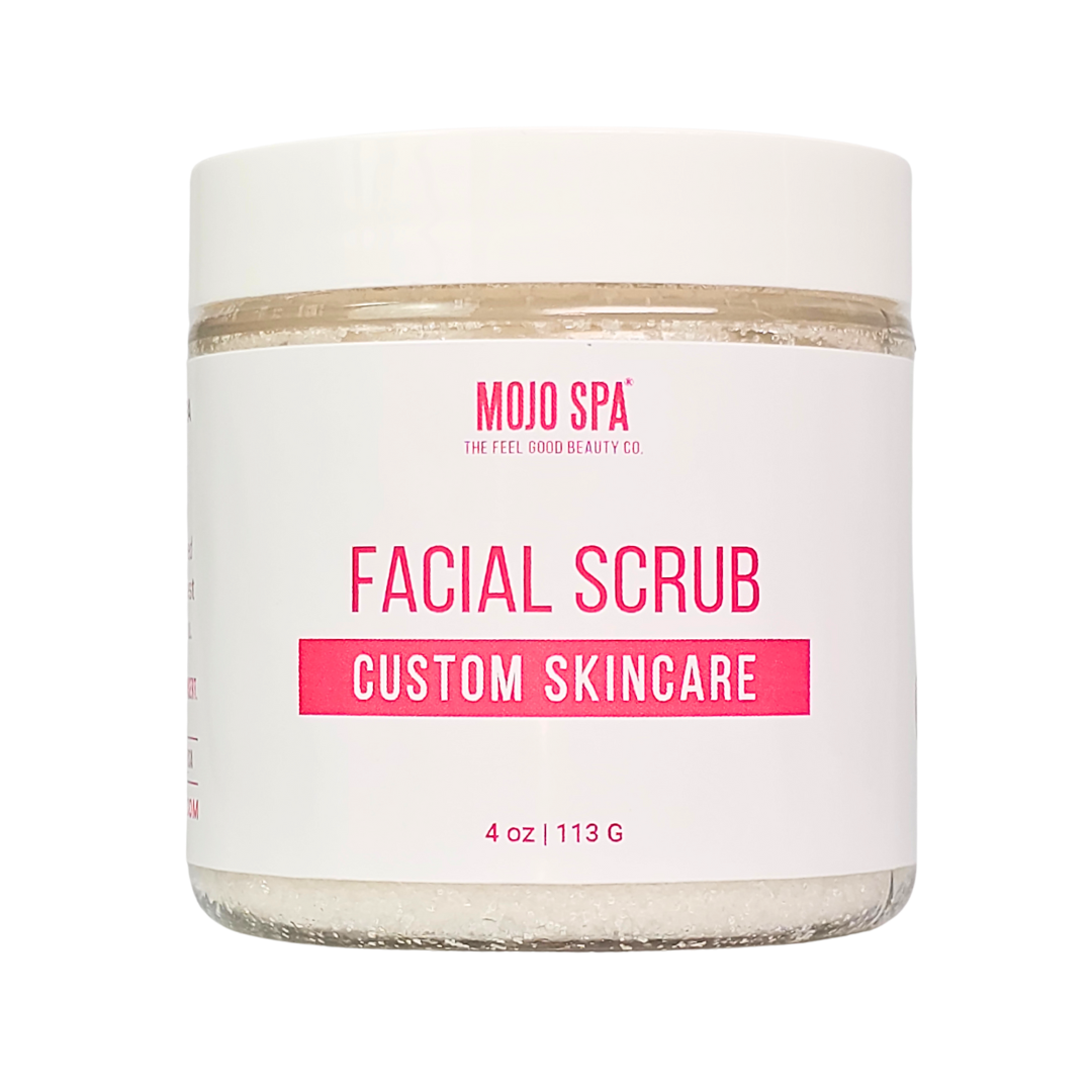 Custom facial scrub in a 4 oz jar of white crystals with a white lid and a Mojo Spa custom skincare label