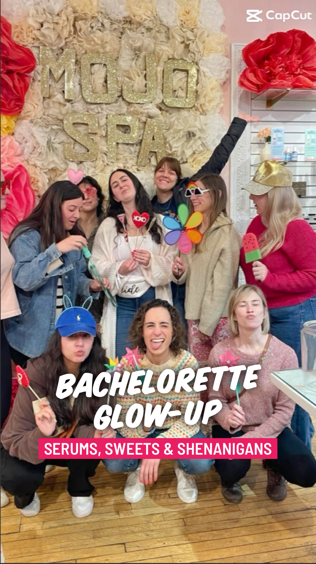 A bachelorette party posing in front of the Mojo Spa sign, with the words Bachelorette Glow-Up, Serums, Sweets and Shenanigans