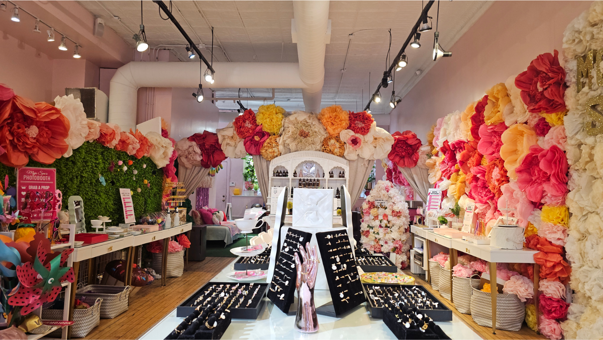 The Mojo Spa shop, its accessory displays under walls of paper flowers