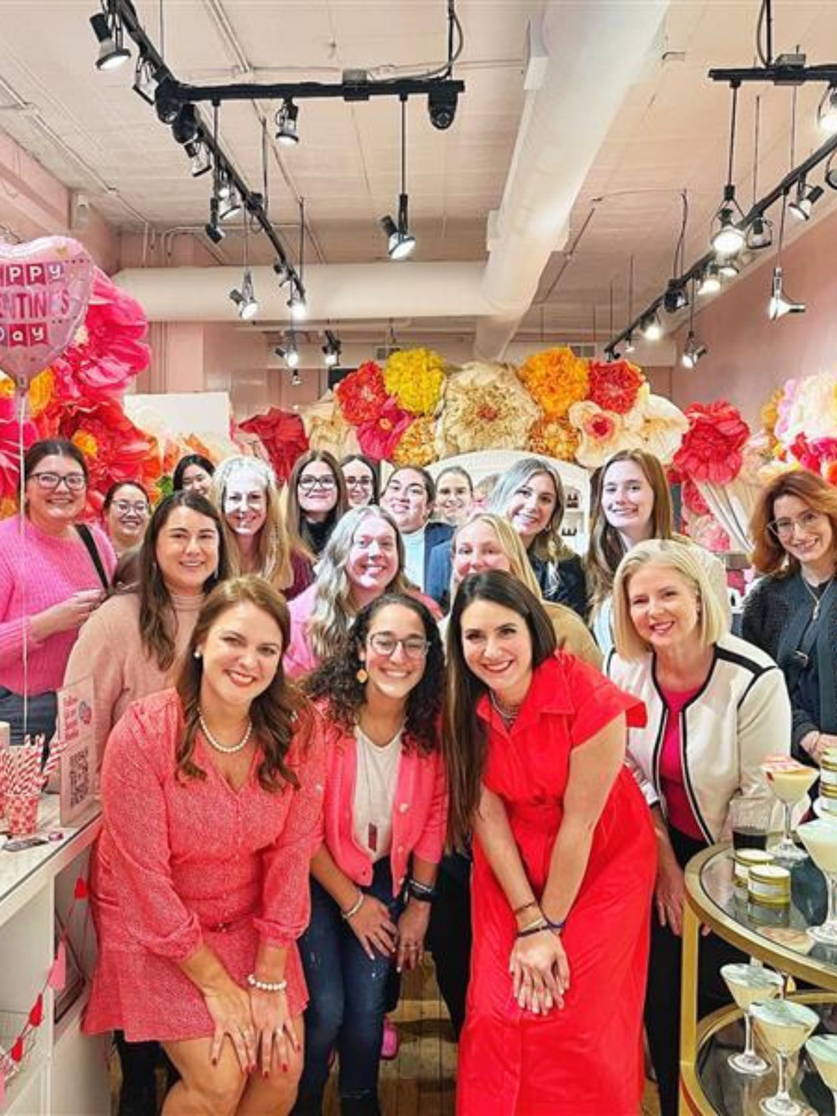 A large group of guests dressed in pink at a party at Mojo Spa