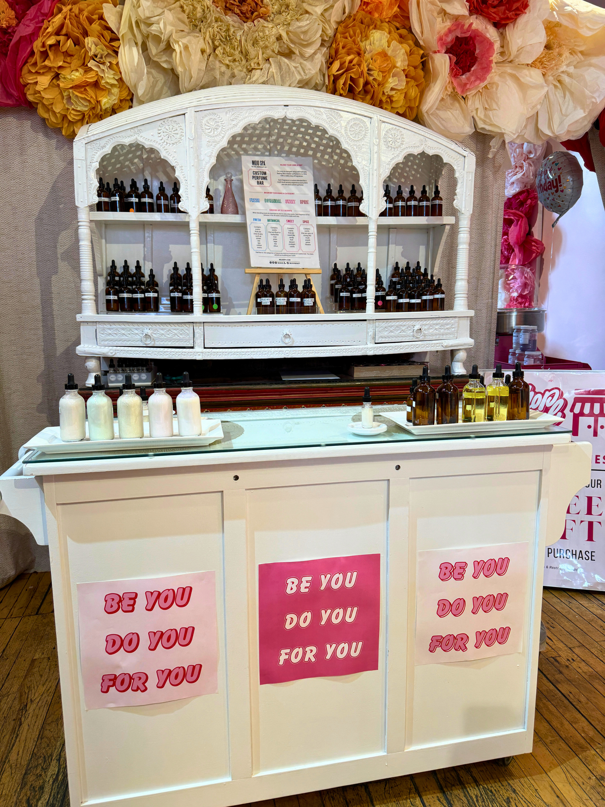 The Beauty Bar's white product hutch, its front reading Be You, Do You, For You