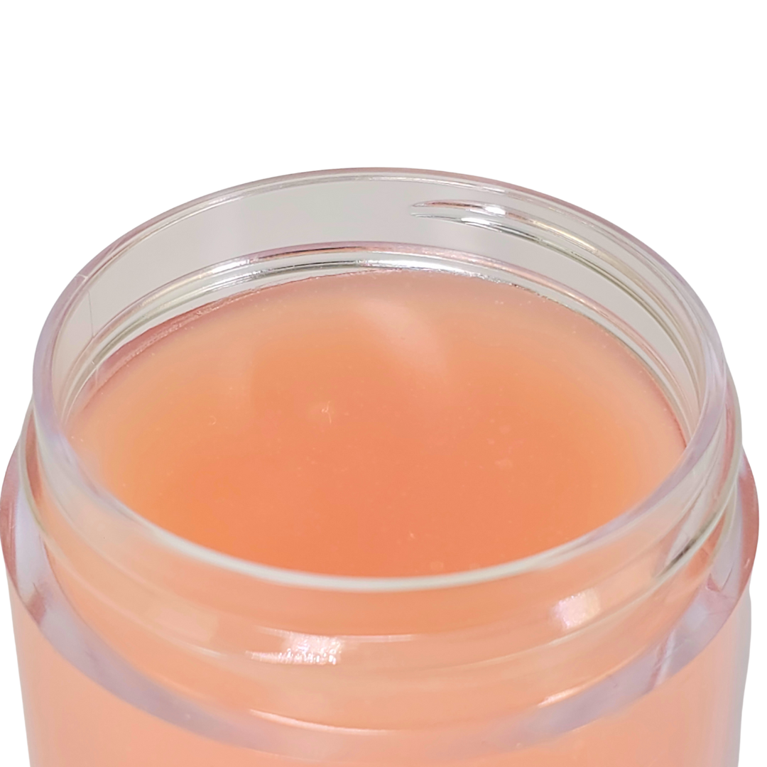 The open clear jar, showing the coral jelly-like mask