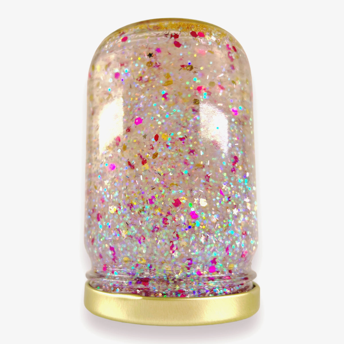 The jar turned upside down, its gold lid at the bottom and multicolour glitter filling the glass