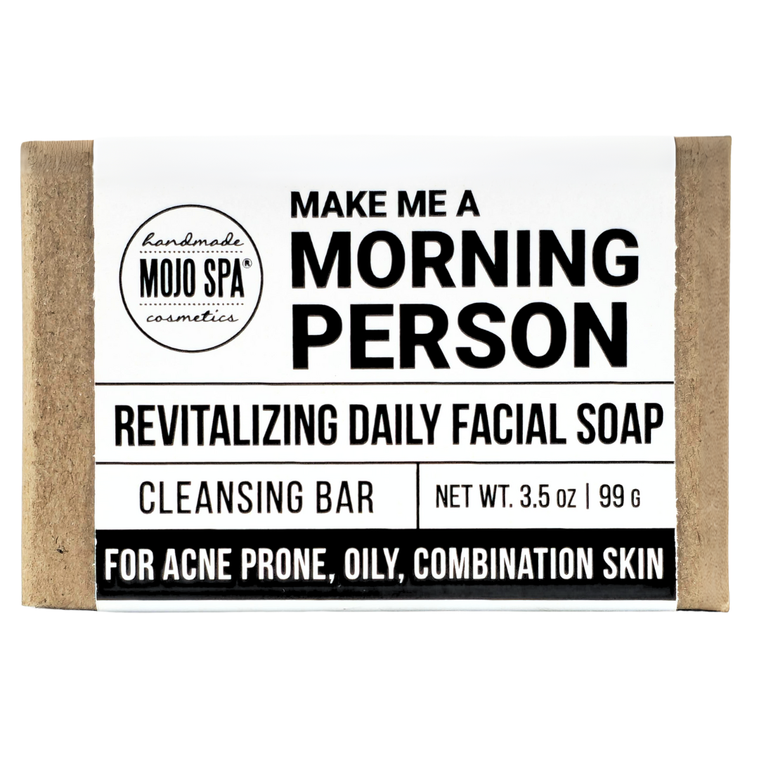Make Me a Morning Person facial soap, a 3.5 oz bar in a kraft paper wrap, label reading Revitalizing Daily Facial Soap