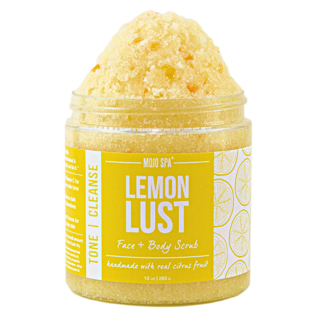 Lemon Lust face and body scrub in a 10 oz clear jar, piled high with pale yellow scrub, yellow and white label