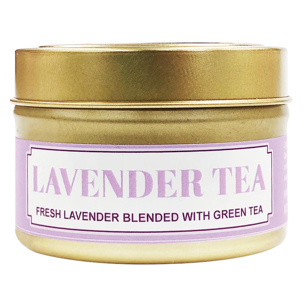 Lavender Tea soy massage candle in a gold tin with a lavender label reading fresh lavender blended with green tea