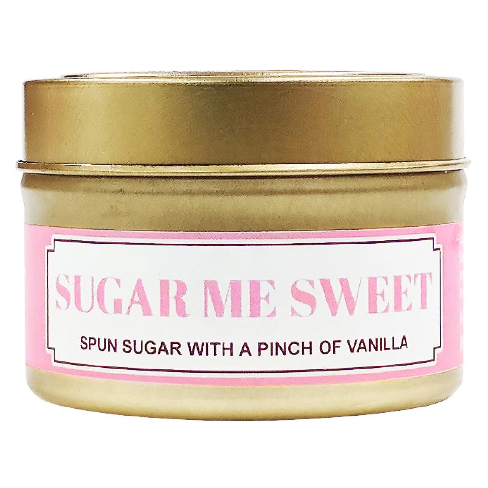 Sugar Me Sweet soy massage candle in a gold tin with a pink and white label reading Spun sugar with a pinch of vanilla