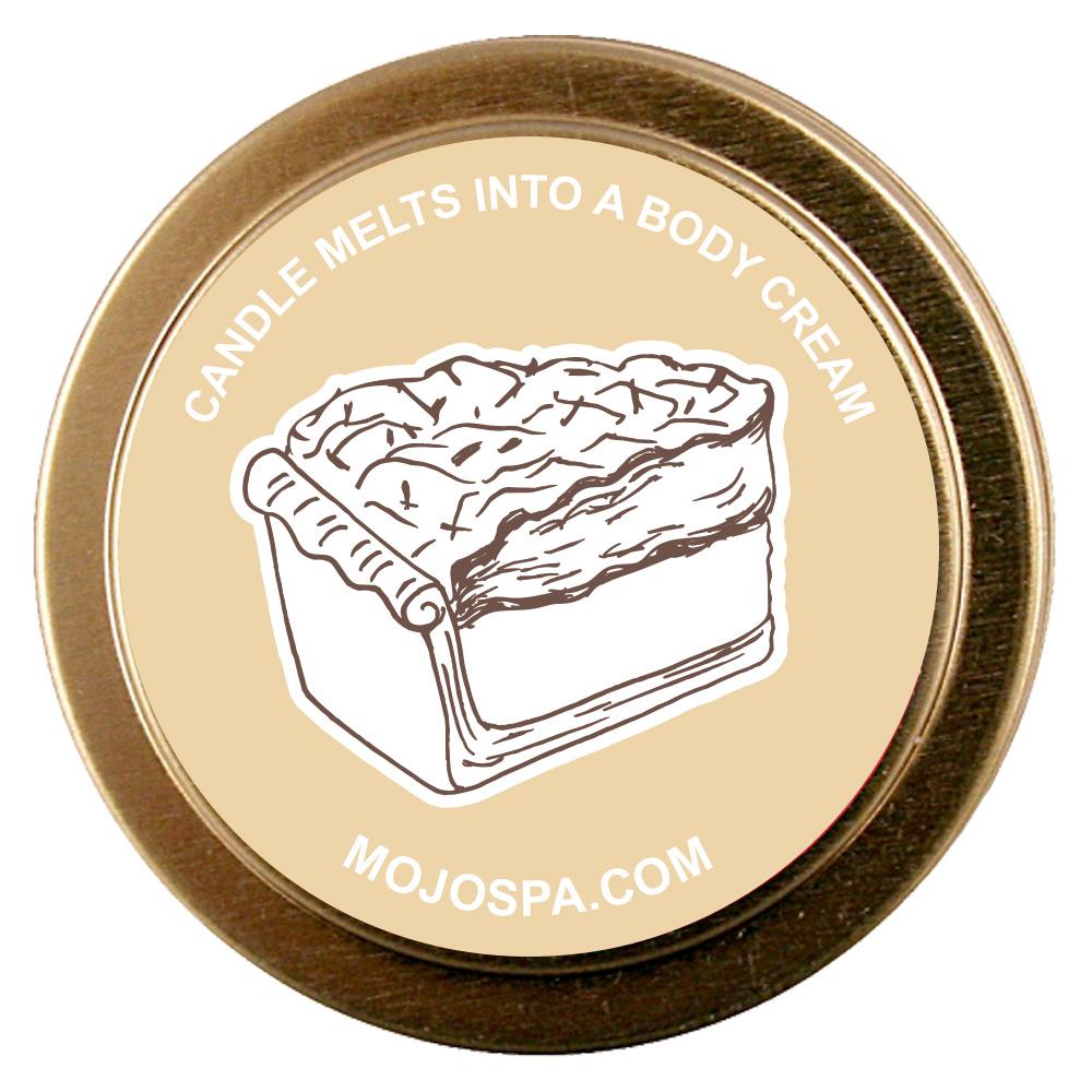 The tin lid from above, with a drawing of a slice of cream pie and the words candle melts into a body cream
