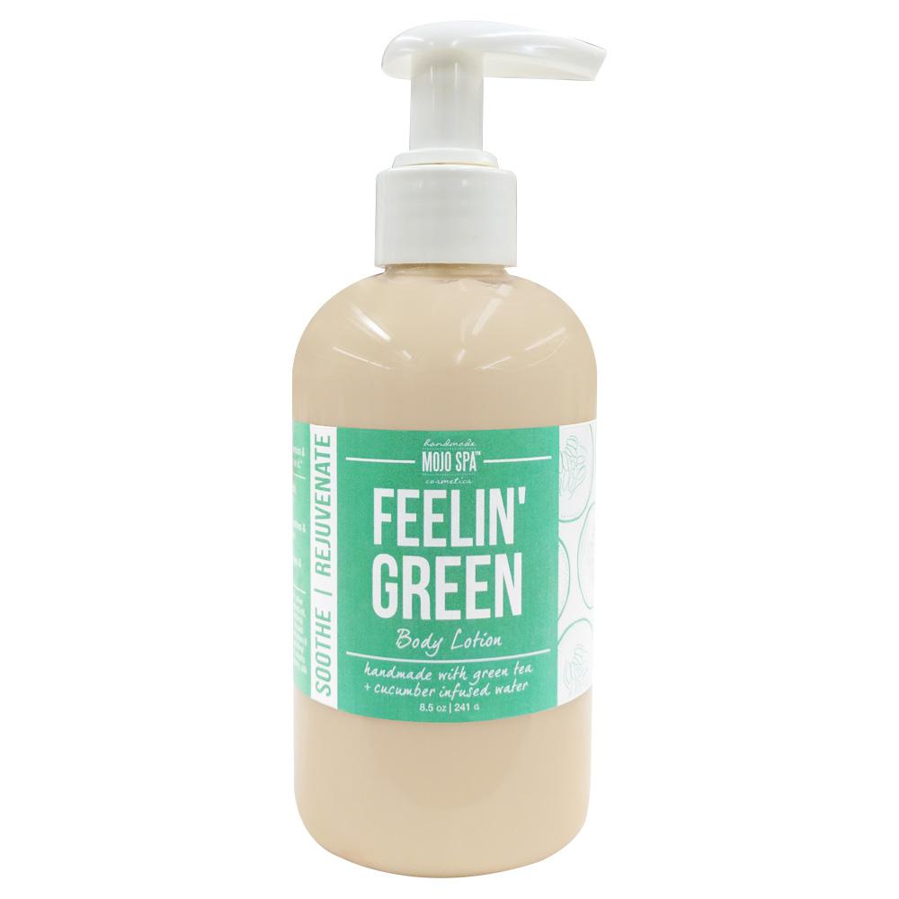 Feelin Green body lotion in a pump bottle with a white pump, tan lotion and a mint green label reading handmade with green tea and cucumber infused water