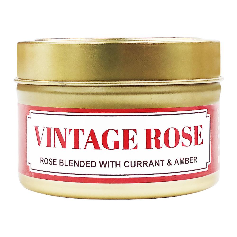 Vintage Rose soy massage candle in a gold tin with a red and white label reading Rose blended with currant and amber