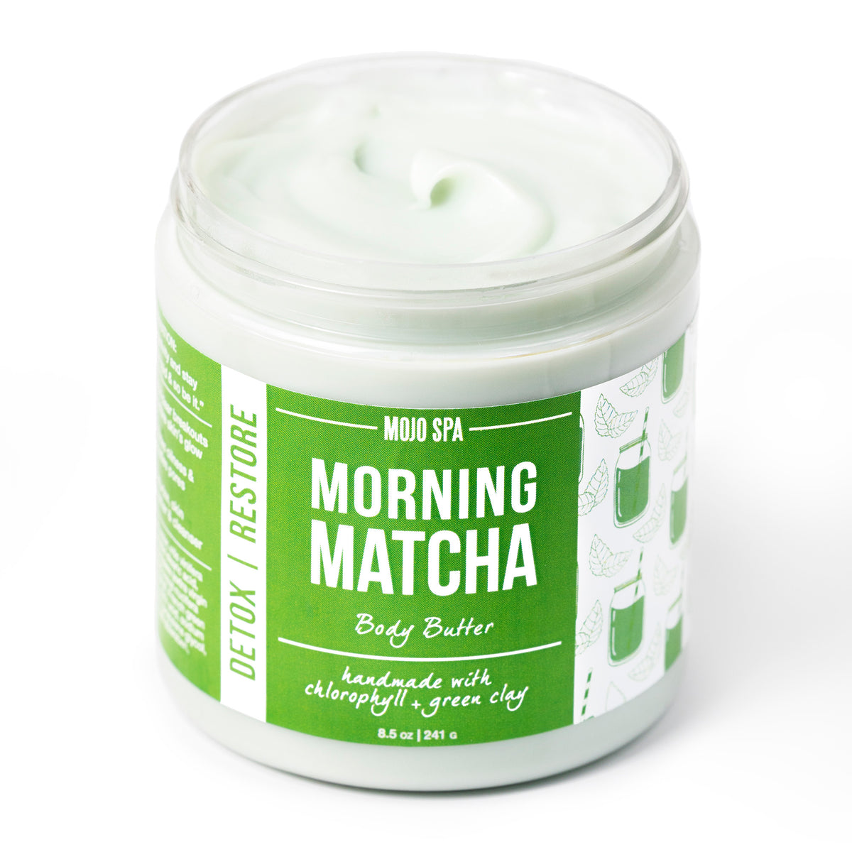 Morning Matcha body butter in an 8.5 oz jar with the lid off, pale green cream above a green label with kale and juice artwork